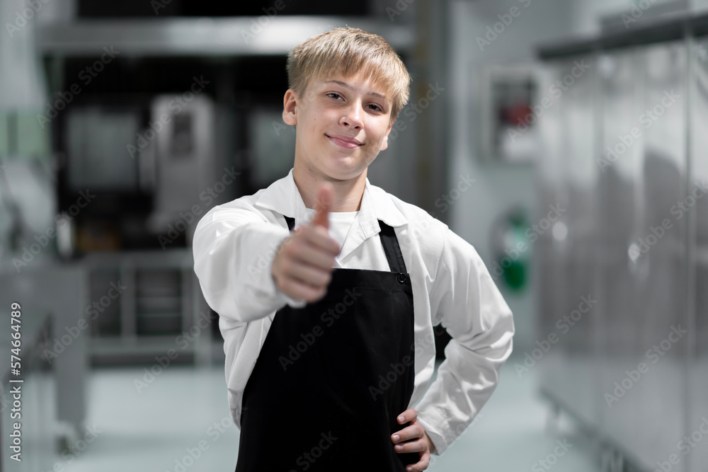 boy student in the kitchen studying cooking boy student in the kitchen studying cooking