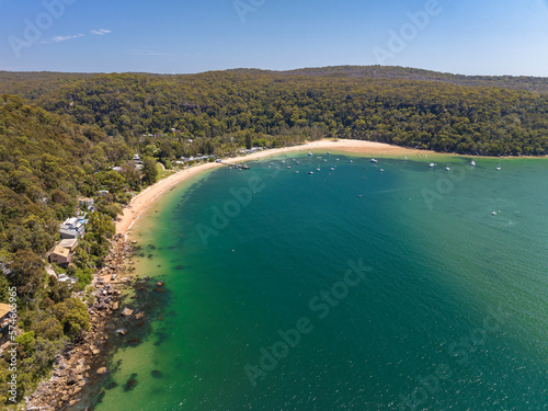 Aerial drone view of Great Mackerel Beach and Wharf on the western shores of Pittwater in Ku-ring-gai Chase National Park, Sydney, NSW, Australia. Mackerel can be reached via ferry from Palm Beach.
