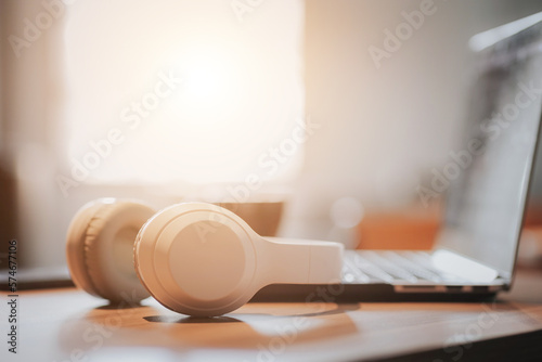Modern wireless headphones and laptop computer while resting. organizing a workspace or home office work from home with copy space for.