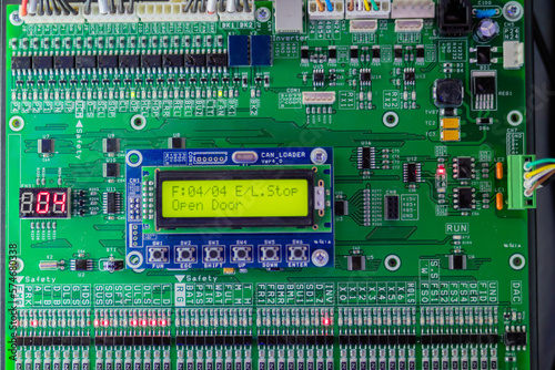 Printed circuit board - pcb for elevator with digital display module at lift exhibition, trade show - close up front view. Technology and electronic concept