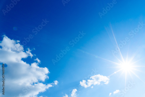 The blue summer sky with white fluffy clouds. Photo from window on the airplane.