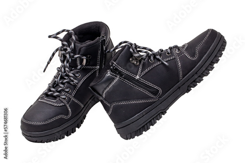 Winter boots. Close-up of a pair elegant black leather winter boots with laces and rivets isolated on white. Clipping path. Macro. Autumn shoe fashion for child boy.