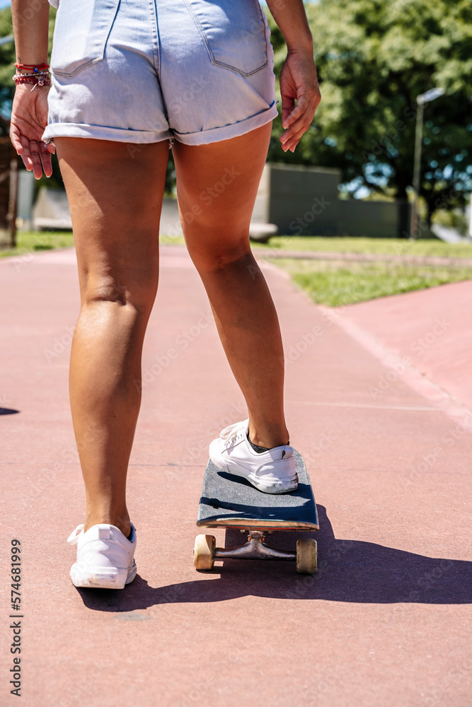  Girl with skateboard in sport lifestyle at summer sunny day. Street urban sporty lifestyle concept.