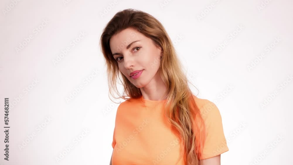 Woman smiling looking at camera. Happy positive emotional blonde girl, long hair. Cheerful lady smile face, beauty self-love concept. Indoors studio, pretty young lady isolated on white background Woman smiling looking at camera. Happy positive emotional blonde girl, long hair. Cheerful lady smile face, beauty self-love concept. Indoors studio, pretty young lady isolated on white background