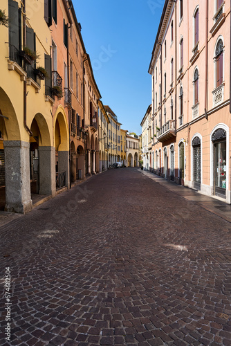 Fototapeta Naklejka Na Ścianę i Meble -  cobbled street with historic tenement houses with shadows in the city of Padua