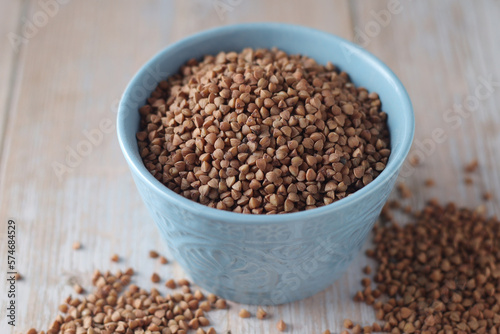 Buckwheat grain in a small ceramic bowl © nastyakamysheva