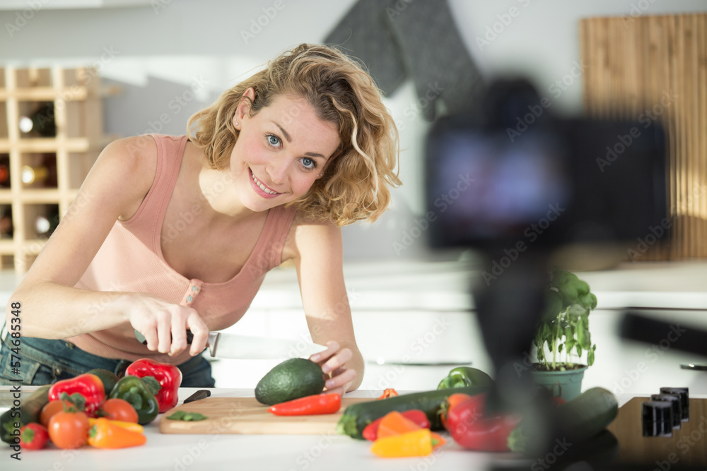 woman recording video in her home kitchen woman recording video in her home kitchen