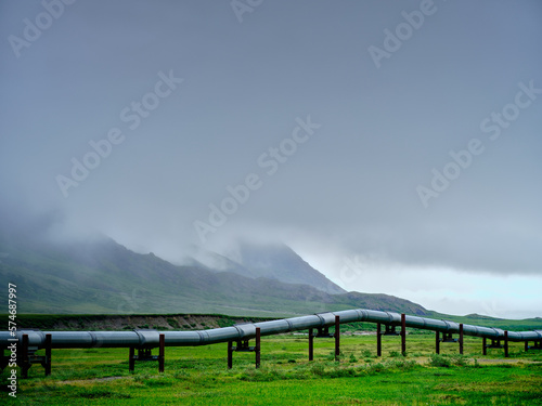 Fog and mist near the village of Nuiqsut Alaska near the North Slope with the Dietrich River and the Alaska Pipeline in the foreground showing the pipeline raised for animal crossing
