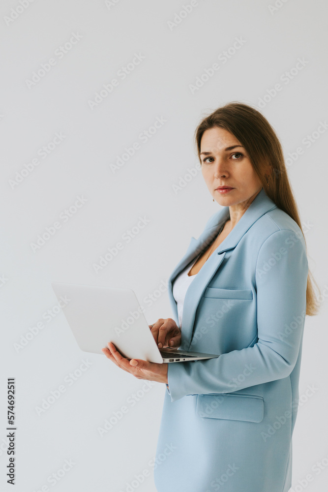 beautiful middle aged real woman portrait with laptop on white background, professional and selfmade businesswoman working online beautiful middle aged real woman portrait with laptop on white background, professional and selfmade businesswoman working online