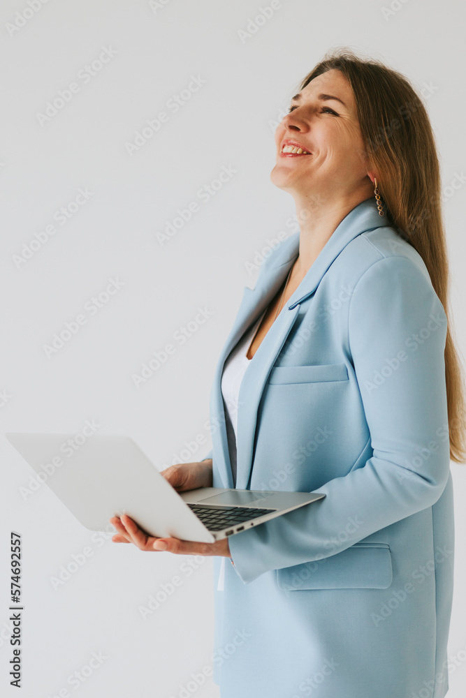 beautiful middle aged real woman portrait with laptop on white background, professional and selfmade businesswoman working online and crying or laughs beautiful middle aged real woman portrait with laptop on white background, professional and selfmade businesswoman working online and crying or laughs