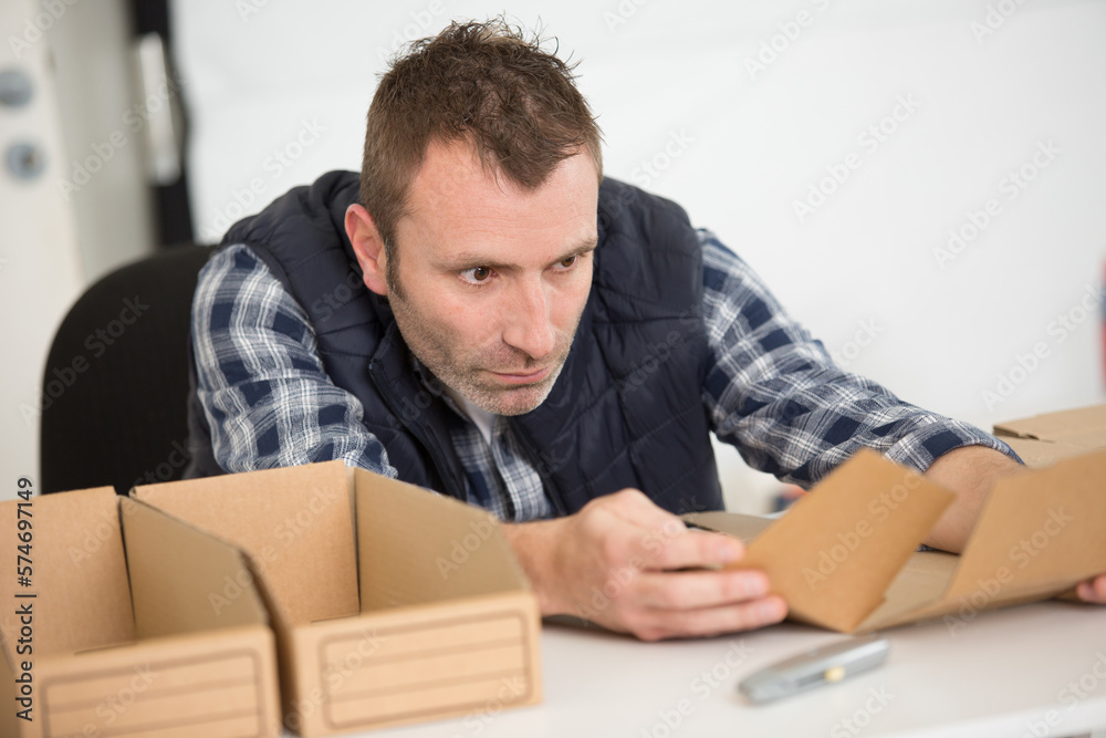 man constructing cardboard box man constructing cardboard box