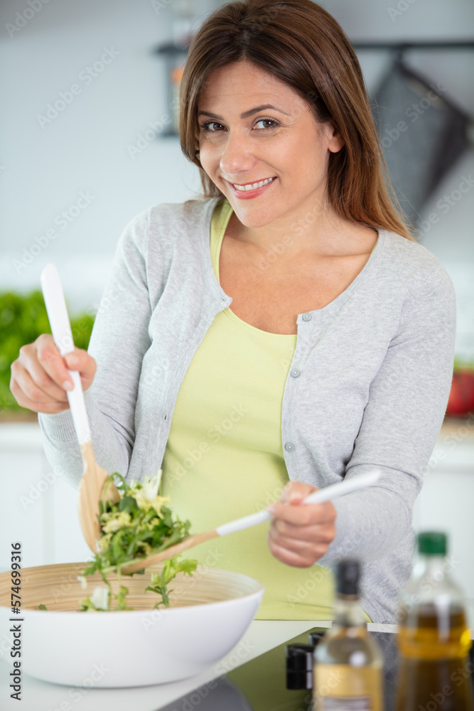 young woman preparing vegetable salad in the kitchen young woman preparing vegetable salad in the kitchen