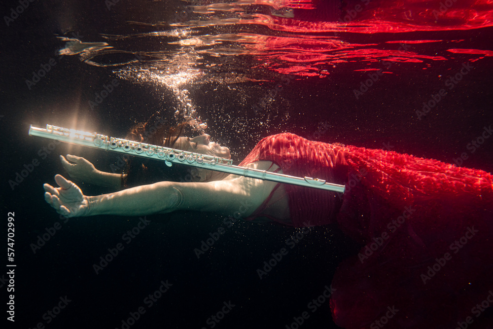 Model underwater in pool with flute Stock Photo Adobe Stock