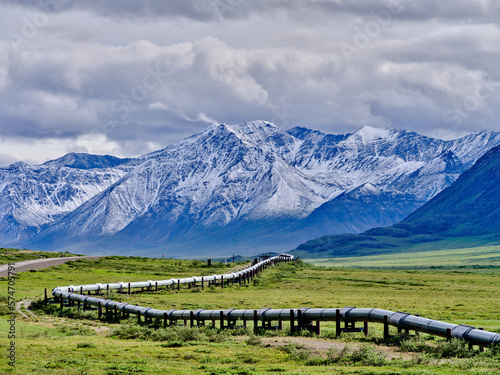 Beautiful rugged and snow-covered Mountain peaks of the Brooks Range in Alaska between the Coldfoot Camp and Prudhoe Bay with the Alaska Oil Pipeline traversing the treeless Tundra photo