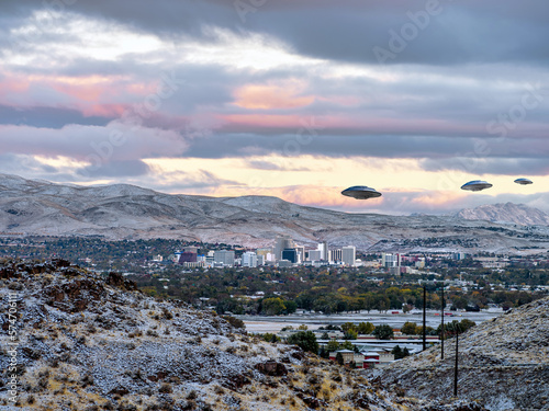 UFO Flying Saucers flying over the Reno, Nevada Cityscape with dramatic clouds and snow capped mountains in the background.