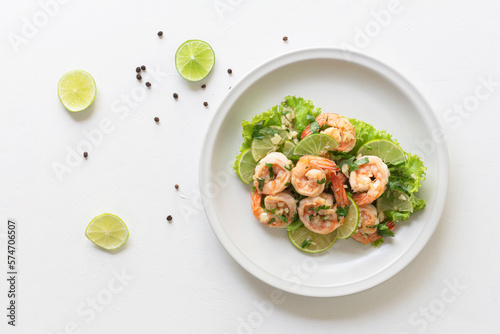 Healthy food stir fried shrimp lemon garlic in bowl on white table.