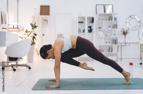 Flexible woman doing lunge yoga in pose
