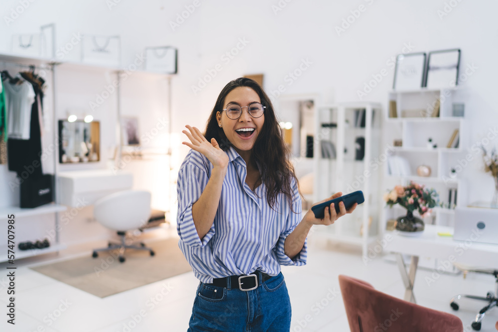 Excited woman with smartphone at home Excited woman with smartphone at home