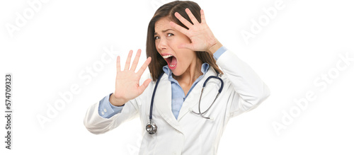 Fotografie Screaming scared doctor woman afraid and frightened covering her face with hands showing funny expression shocked and surprised