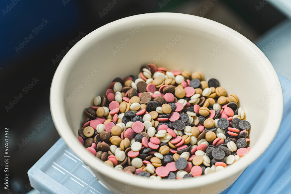 Mixed white, ruby, dark chocolate callets in a bowl. High quality photo Mixed white, ruby, dark chocolate callets in a bowl. High quality photo