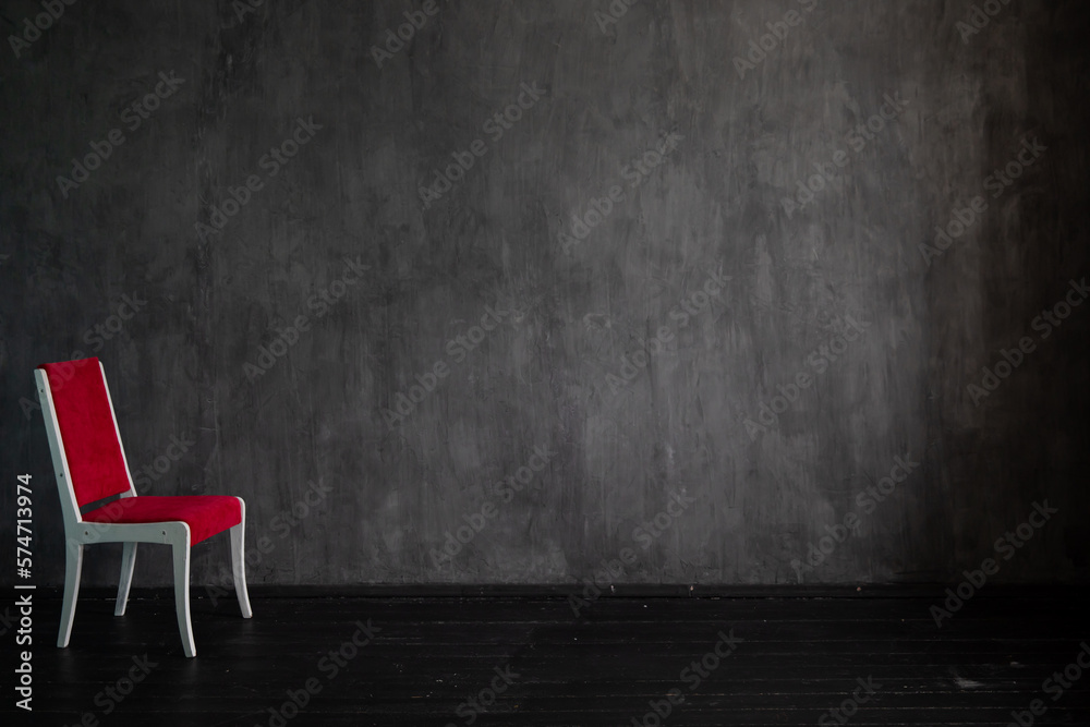 one red chair on a dark background in the room interior in the apartment one red chair on a dark background in the room interior in the apartment