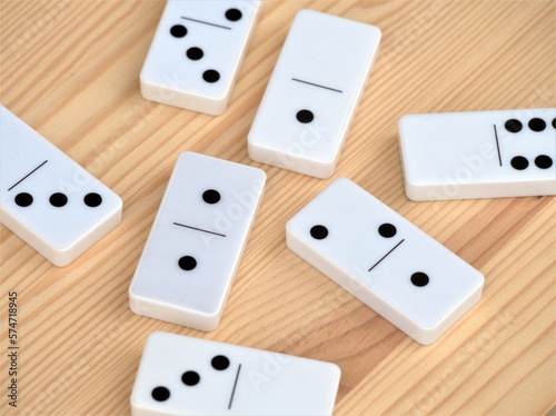 Dominoes on a wooden table. Board games and fun leisure activities. Set of classic domino tiles