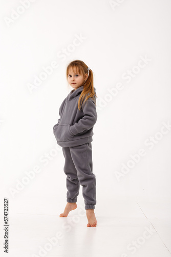 Little girl in thermal clothes, on a white background. photo