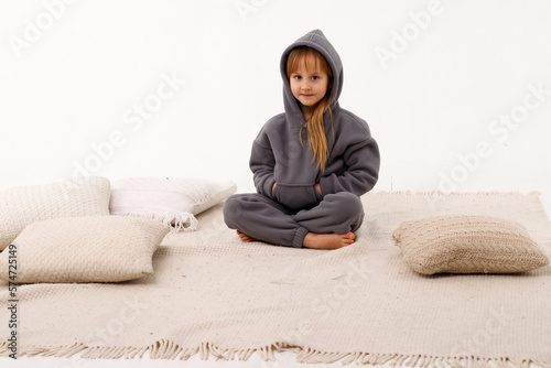 Little girl in thermal clothes, on a white background. photo