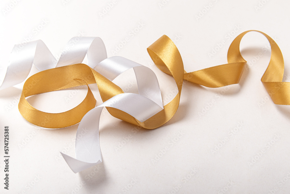 Two ribbons for wrapping gifts on white background. Gold and white ribbon Two ribbons for wrapping gifts on white background. Gold and white ribbon