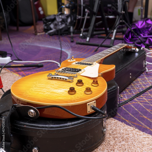 View of an electric guitar located on a hard case in the rehearsal room