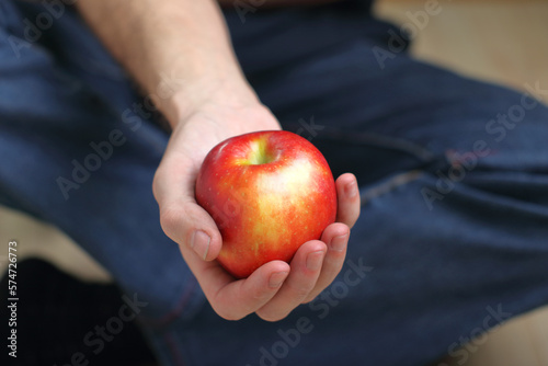 person holding a red apple