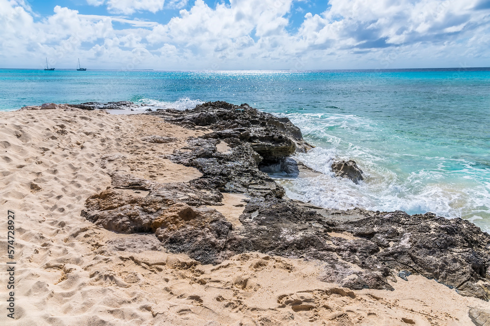 A view out to sea from a rocky headland on the shoreline of the island of Grand Turk on a bright sunny morning