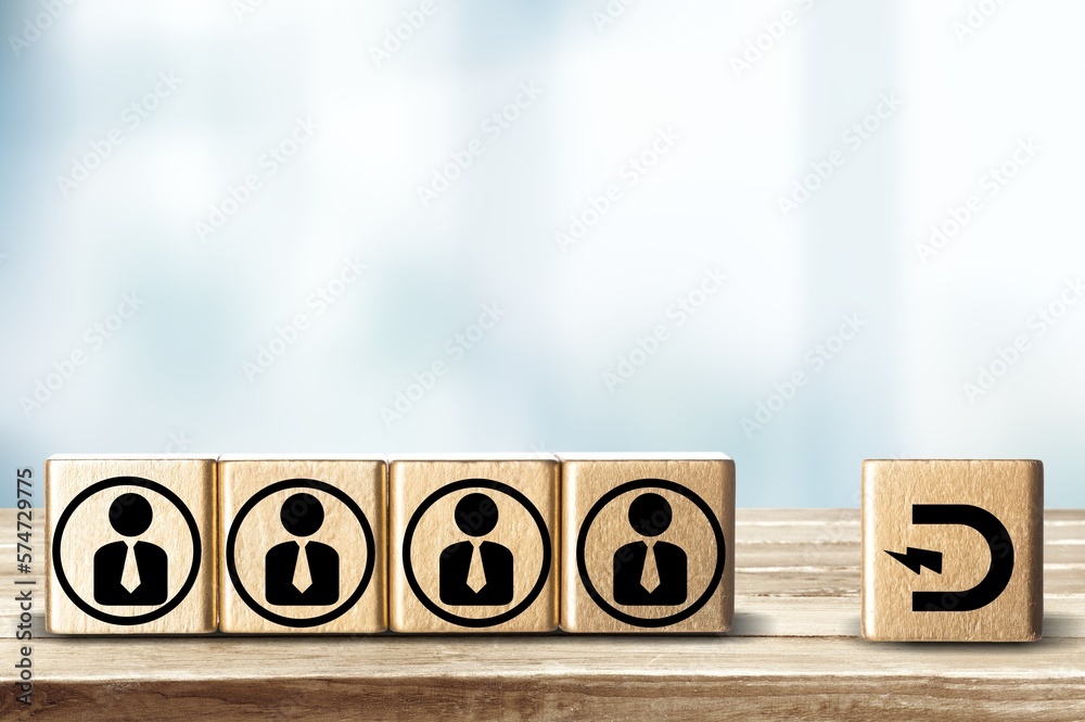 Magnet and people icons on wooden blocks Magnet and people icons on wooden blocks