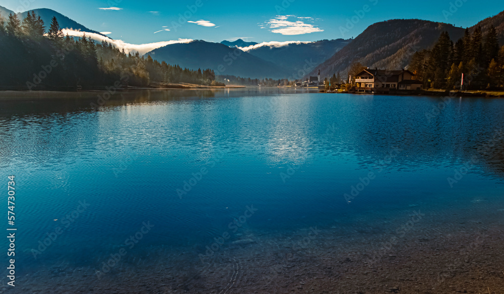 Beautiful alpine autumn or indian summer landscape view with reflections at the famous Pillersee lake at Saint Ulrich, Tyrol, Austria