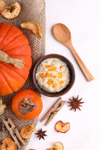 Autumn background decoration made of dried leaves and pumpkins on a white concrete, slate background. Flat layout, top view of autumn, the concept of autumn, Thanksgiving.