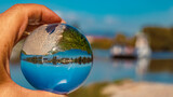 Crystal ball autumn or indian summer landscape shot at Stephansposching ferry, Danube, Bavaria, Germany