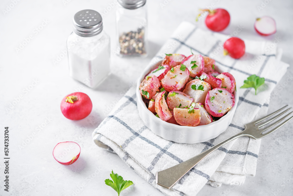 Roasted spiced radish with parsley in a bowl Roasted spiced radish with parsley in a bowl