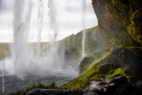 Seljalandsfoss Iceland is a stunning waterfall that allows visitors to walk behind the cascading water.