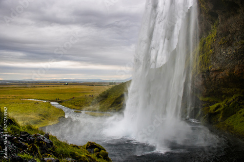 Seljalandsfoss Iceland is a stunning waterfall that allows visitors to walk behind the cascading water.