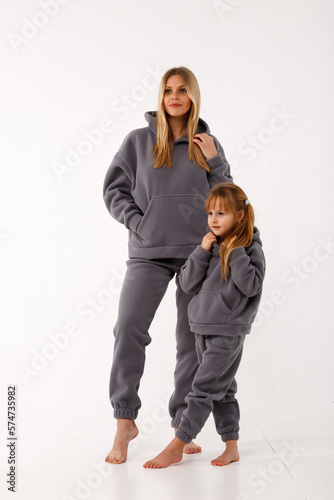 Sporty mom and her little daughter in thermal clothes.