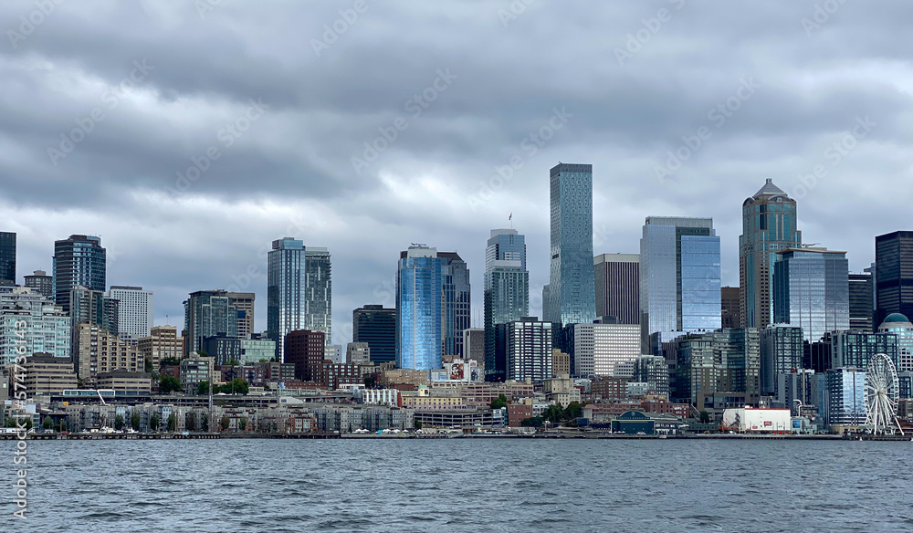 City of Seattle skyline, with sun reflecting on buildings, as seen from a boat on Elliott Bay.