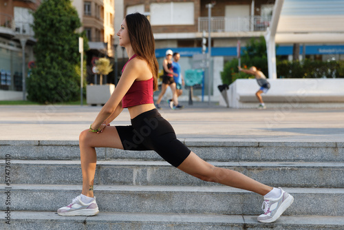 Sporty stylish girl goes in for sports and walks in the city