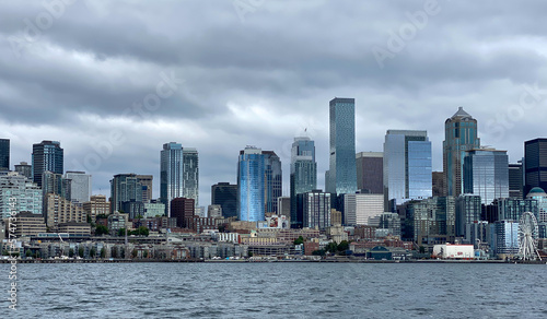 City of Seattle skyline, with sun reflecting on buildings, as seen from a boat on Elliott Bay. © Dawn