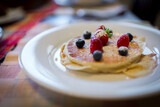 Homemade buttermilk pancakes with fresh berries and powdered suger toppings