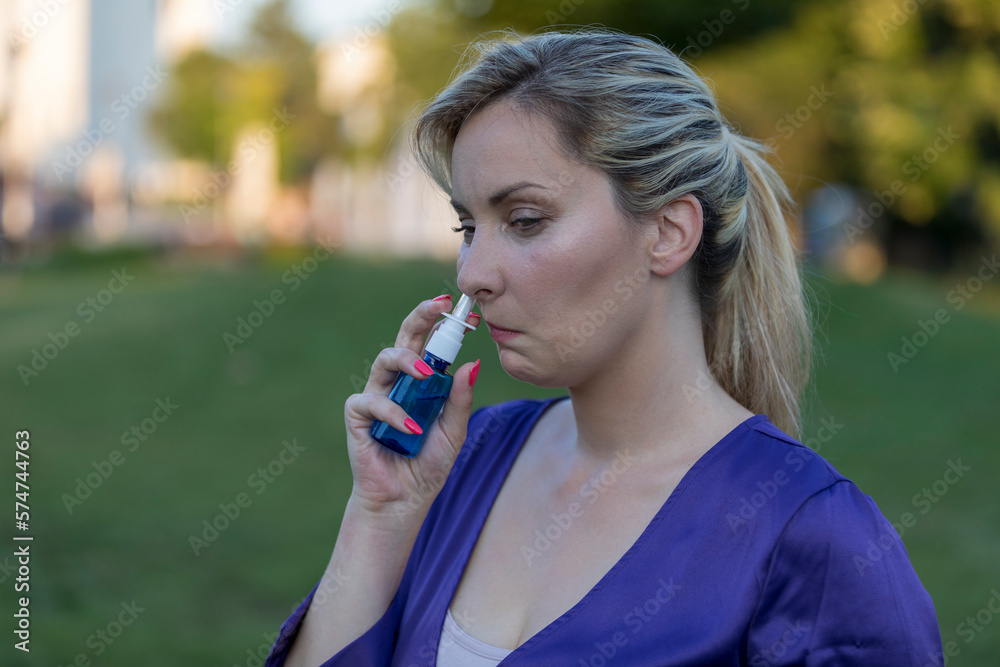 An asthmatic woman who takes an inhaler and has an asthma attack. She has a problem with asthma and holding an inhaler.