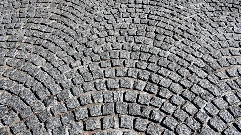 Cobblestone pattern on the road. Cobblestone texture on the street, close up. Brick floor tiles. Cobblestone pattern on the road. Cobblestone texture on the street, close up. Brick floor tiles.
