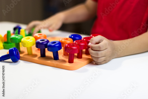 Children's pens playing plastic mushrooms on a white background