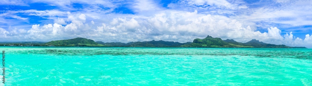 Tropical background - blue sunny sky and turquoise sea. Tropics vacation, Mauritius island, Blue bay