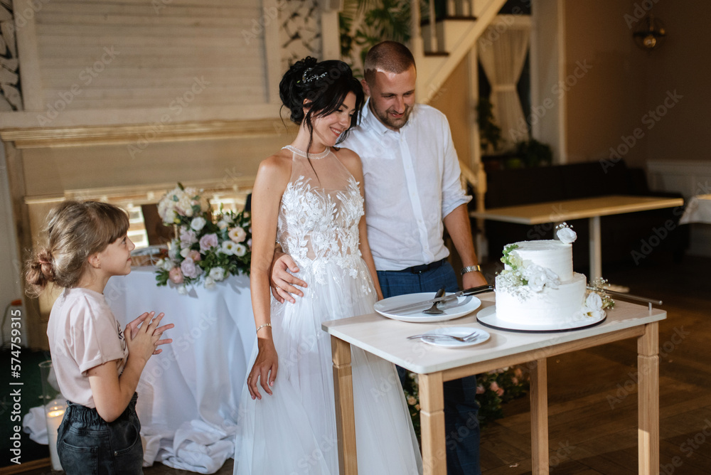 newlyweds happily cut and taste the wedding cake newlyweds happily cut and taste the wedding cake