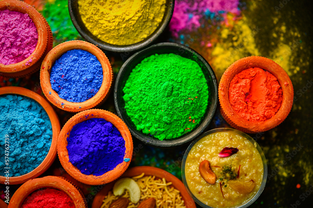 top view of colorful traditional holi powder in bowls isolated on dark background.Space for text . happy holi.Concept Indian color festival called Holi top view of colorful traditional holi powder in bowls isolated on dark background.Space for text . happy holi.Concept Indian color festival called Holi